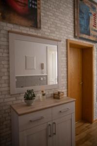 a bathroom with a sink and a mirror at FeWo LUNA in Riesa