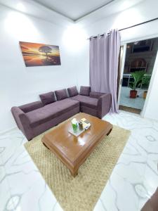 a living room with a couch and a coffee table at Horizon Bleu Cozy prés de la Plage avec Balecon in Dakar