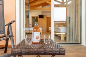 a bottle of beer and two glasses on a table at Agritur Fiordaliso in Predaia