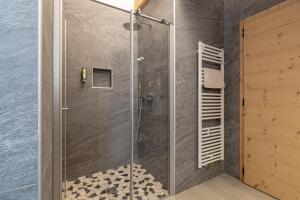 a shower with a glass door in a bathroom at Agritur Fiordaliso in Predaia +46 photos