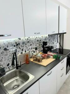 a kitchen with a sink and a counter top at VRACHOS HOUSE "In the heart of Skopelos Town" in Skopelos Town +59 photos