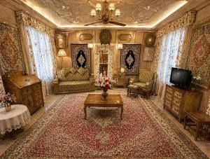 a living room with a couch and a table at Dilnaaz Group Of Houseboats in Srinagar