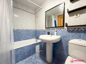 a bathroom with a sink and a toilet and a mirror at The Skyline in Grao de Castellón