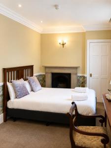 a bedroom with two beds and a fireplace at The Lairgate in Beverley
