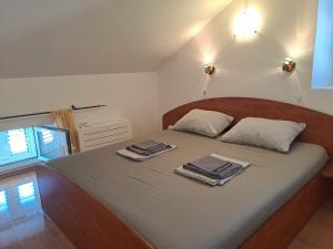 a bedroom with a bed with two towels on it at Greta in Vrbnik