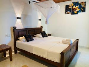 a bedroom with a large bed in a room at Fairview Dill homestay in Sigiriya