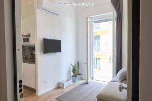 a living room with a tv on a white wall at Urban Chic, Terre Marine in La Spezia