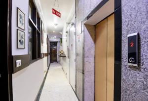 a corridor of a hospital with purple walls at FabHotel Delhi Continental in New Delhi