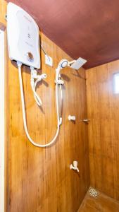 a shower in a bathroom with a wooden wall at lake Edge Dambulla in Dambulla +52 photos