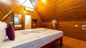 a bedroom with a bed in a wooden room at lake Edge Dambulla in Dambulla