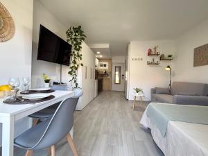 a living room with a desk and a room with a couch at Hercules Cozy Studio - City Center and Near Beach in Benalmádena