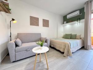 a living room with a couch and a bed at Hercules Cozy Studio - City Center and Near Beach in Benalmádena +15 photos