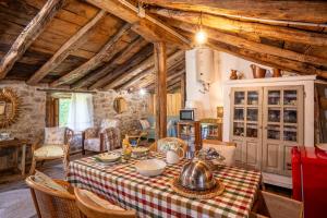 a dining room with a table with a tea kettle on it at Vivienda pasiega LO LUCAS 1920 in San Roque de Ríomiera