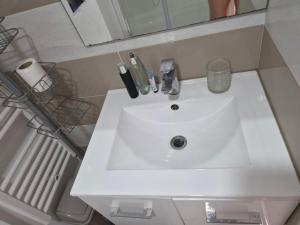 a white sink in a bathroom with a mirror at Studio Danna in Menton