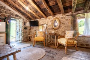 a living room with a table and chairs at Vivienda pasiega LO LUCAS 1920 in San Roque de Ríomiera