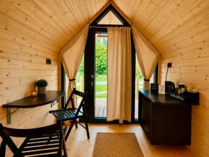a room with a desk and a window in a cabin at Bela Resort - Glamping in Motnik