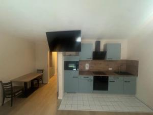 a kitchen with a table and a stove top oven at Stay Zentral Dresden in Dresden +10 photos