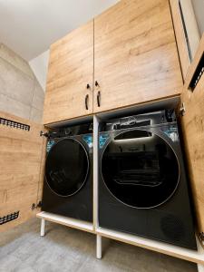 a laundry room with a washer and dryer at Bela Resort - Glamping in Motnik +13 photos