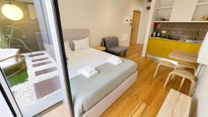 a small bedroom with a bed and a kitchen at Heritage Apartments in Câmara de Lobos +30 photos