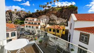 a balcony with a view of a city at Heritage Apartments in Câmara de Lobos