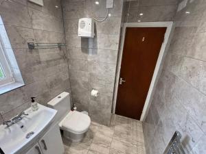 a bathroom with a toilet and a sink at 1 Bedroom Chalet in West Runton +3 photos