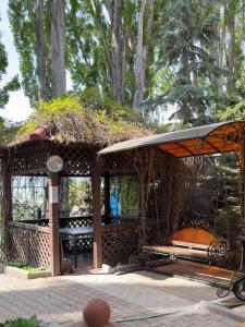 a gazebo with a bench and a table at Солнышко VIP 1 in Chok-Tal