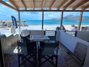 a bar with chairs and a view of the beach at Kedros -Small Seaside Studio -Ground Floor in Elafonisos