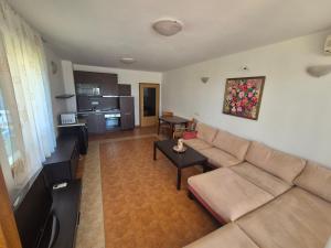 a living room with a couch and a table at Helios Beach Apart Garden in Pomorie