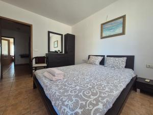 a bedroom with a large bed in a room at Helios Beach Apart Garden in Pomorie