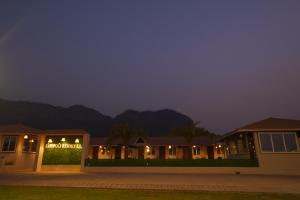 a building with a sign that reads royal hotel at night at khopoli resort in Khopoli