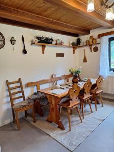 a dining room with a wooden table and chairs at Jirkova chata in Lipova Lazne