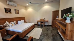 a bedroom with a bed and a table with a vase of flowers at Escape Villa - Kilimanjaro in Moshi +41 photos