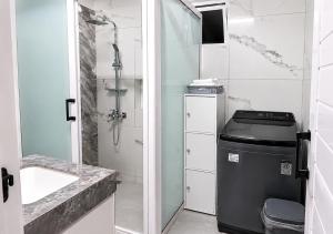 a bathroom with a sink and a trash can at Gracious Haven - Fully Equipped Rooftop with private terrace house in Saint-Pierre, Moka in Moka +18 photos