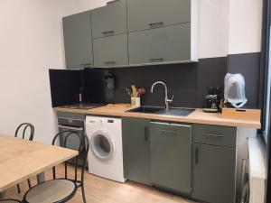 a kitchen with a sink and a washing machine at Le Cleyputz in Dunkerque +8 photos