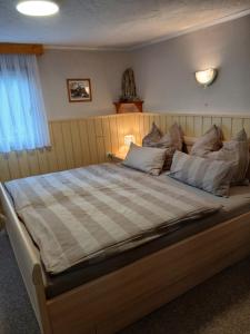 a bedroom with a large bed with a checkered blanket at Klein Hohe Fichten in Kurort Altenberg