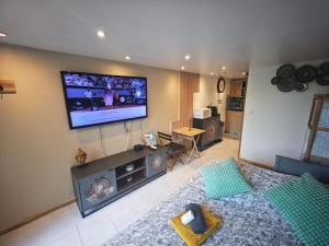 a living room with a flat screen tv on the wall at Nature stopover in green Provence in Artigues +10 photos