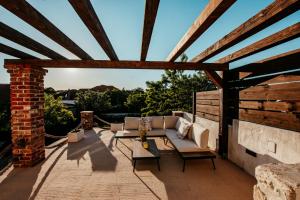 a patio with couches and a brick wall at Villa Gland in Nin +71 photos