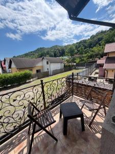 a balcony with a bench and a view at Vila Mina in Ocnele Mari