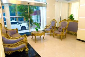 a group of chairs and a table in a room at Alpha Suites Salalah in Salalah