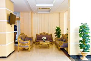 a waiting room with couches and a table and plants at Alpha Suites Salalah in Salalah