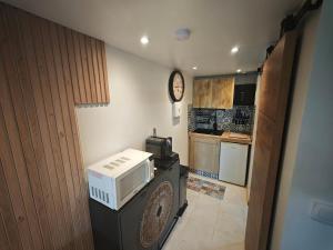 a kitchen with a microwave on top of a refrigerator at Nature stopover in green Provence in Artigues