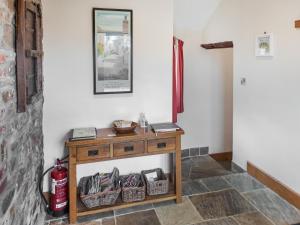 a room with a table with baskets and a fire extinguisher at Jacks Barn - Hssu in Welcombe