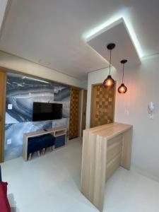 a living room with a bed and a television at 302 · 302 2qtos Encantador com garagem grátis in Belém
