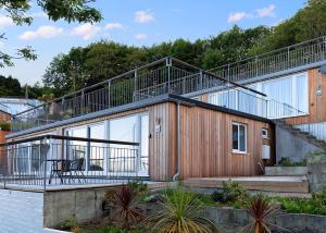 a house with a large deck on the side of it at Millendreath Beach Resort in Looe