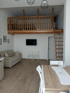 a living room with a couch and a loft at A Casuzza in Balestrate