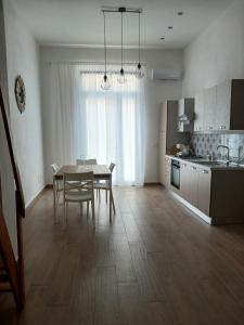 a kitchen and dining room with a table and chairs at A Casuzza in Balestrate