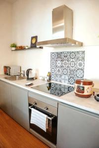 a kitchen with a sink and a stove at Zen Suite - 50m from Metro M1 - Direct to F1 Monza, Fashion Week, Duomo in Milan