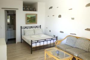 a living room with a couch and a table at Rosalie Home - Open Sea Duo in Tinos