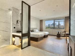 a hotel room with a bed and a table at Hotel Hualton in Alcobendas