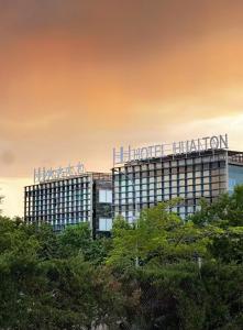 a building with a sign on top of it at Hotel Hualton in Alcobendas